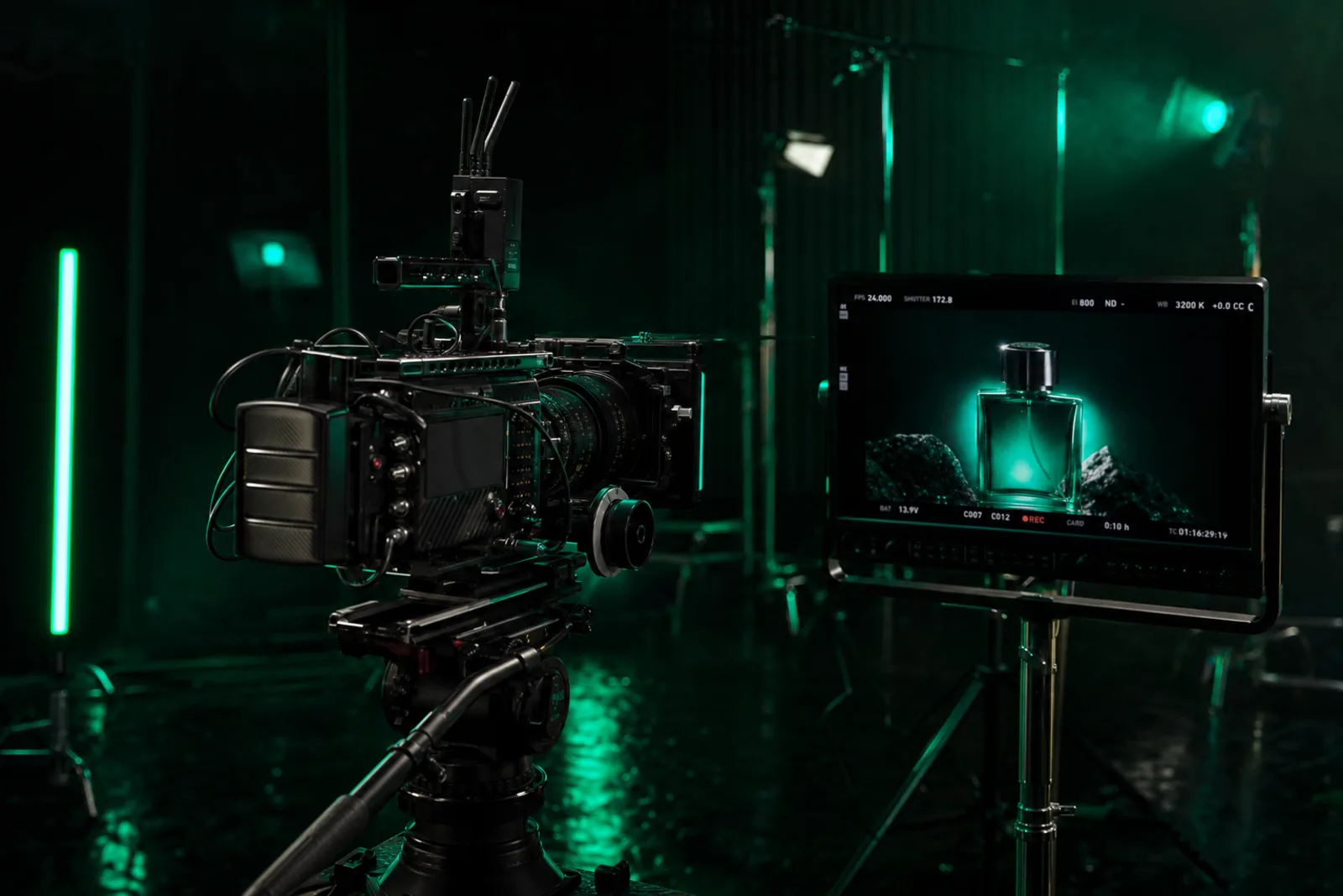Cinematic frame of a cinema camera filming a product shot on a dark set